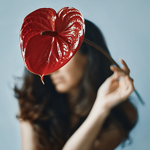 Portrait of woman with Anthurium by Magda Lates